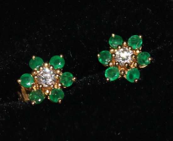 A pair of gold, emerald and diamond cluster ear studs.